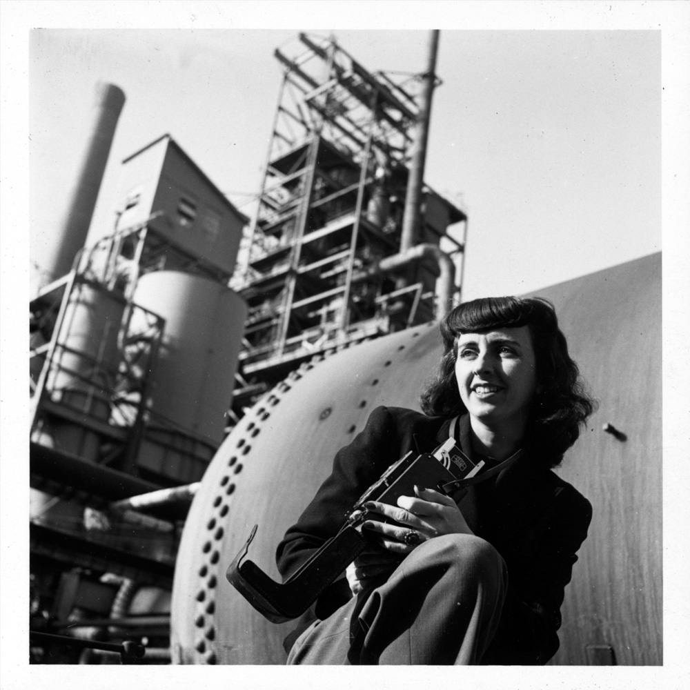 Black and white image of Farm Security Administration and Office of War Information photographer Esther Bubley outside a factory in Bayway, New Jersey, 1943.]