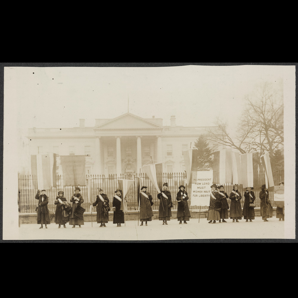 Pennsylvania suffragists protesting in front of the White House, 1917. Their banner reads “Mr. President how long must women wait for liberty?”]
